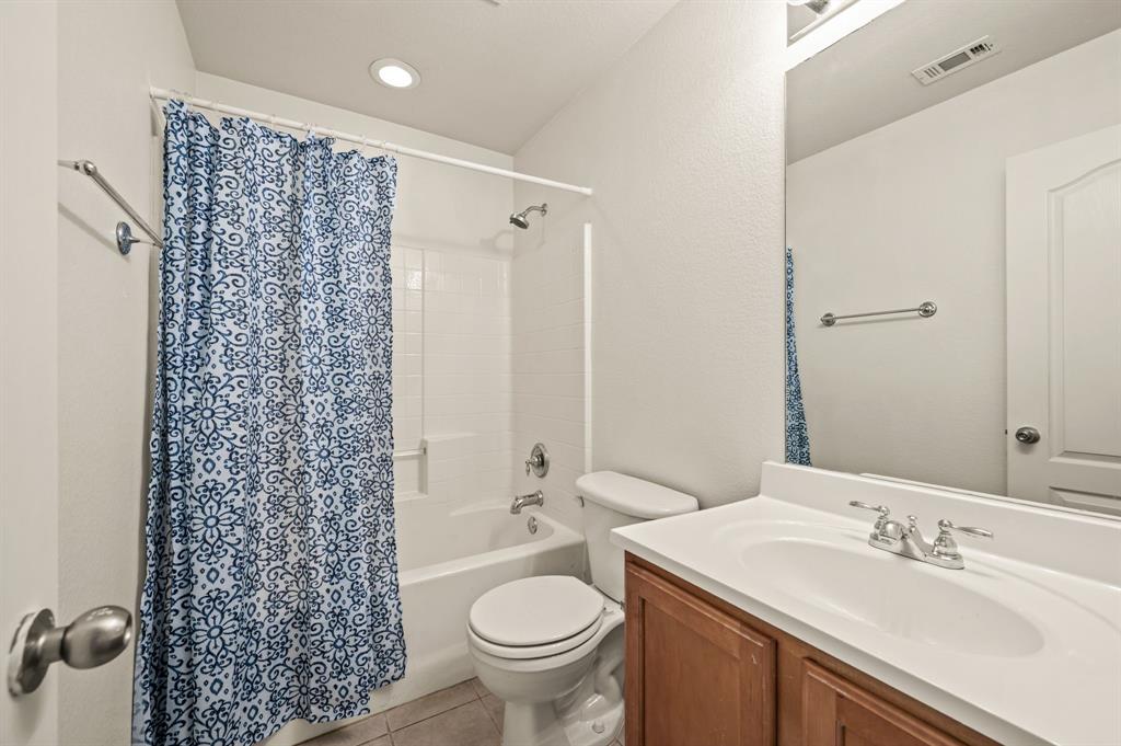 808 Briar Ridge Drive Keller, TX 76248 - Photo 31 of 40 Full bathroom featuring a single vanity with wood-finish cabinetry, a white countertop, and a built-in sink