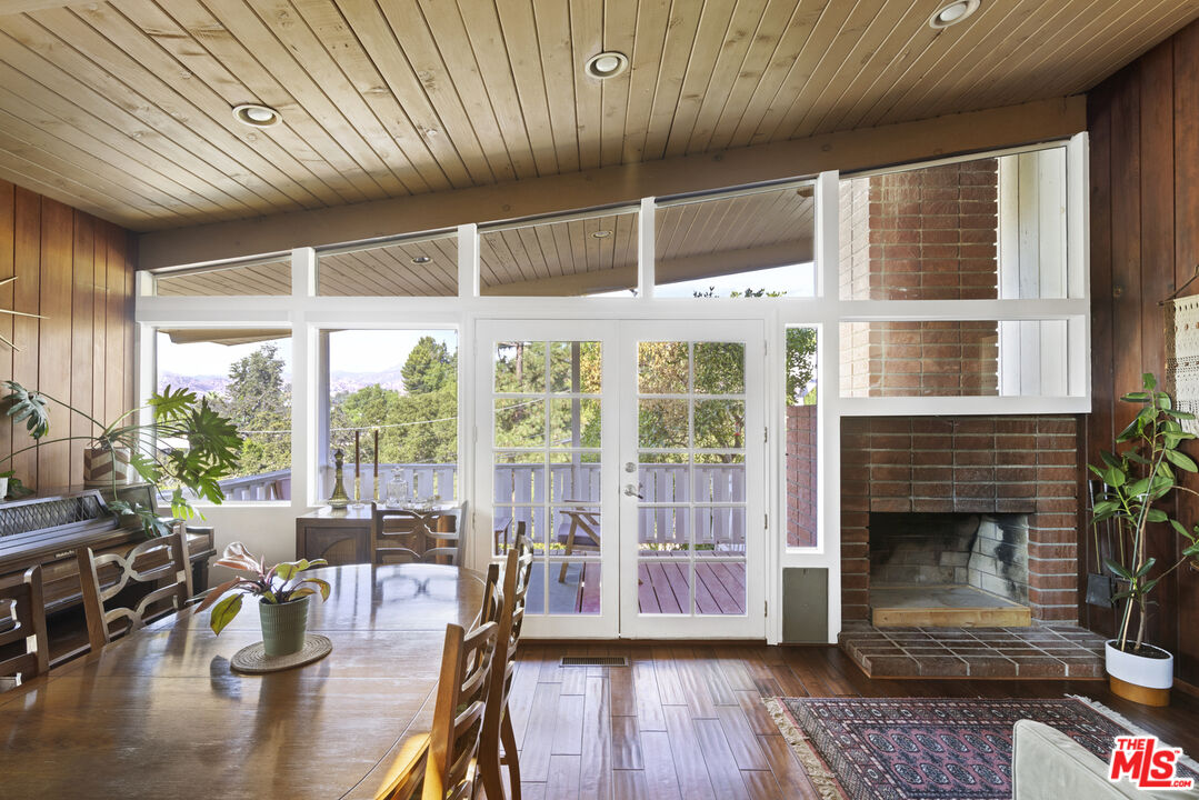 a living room with furniture a wooden floor and a fireplace