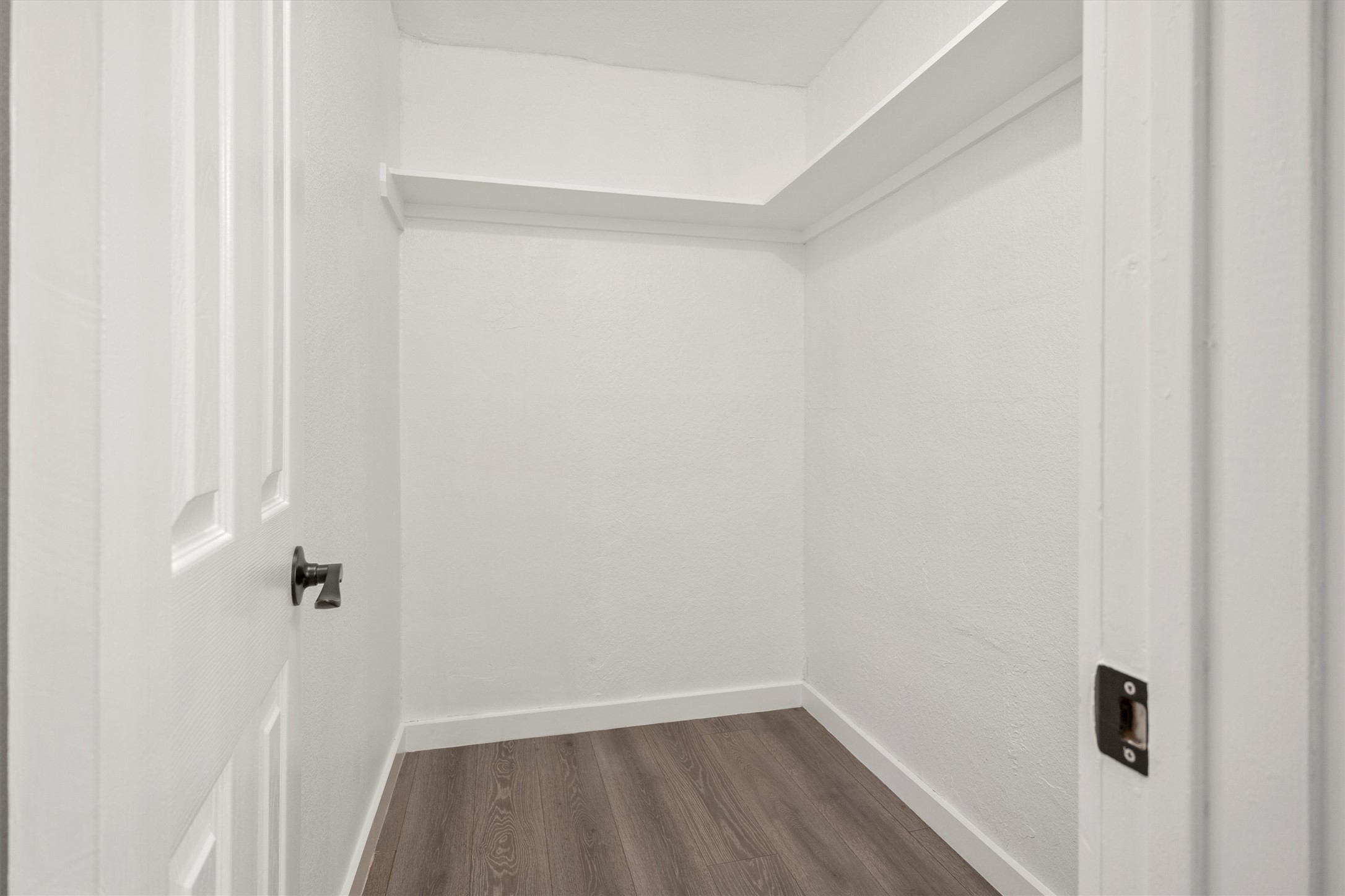 502 Pin Tail Lane Taylor, TX 76574 - Photo 18 of 26 Compact storage area featuring wood-finish flooring, crisp white walls, and a recessed ceiling element