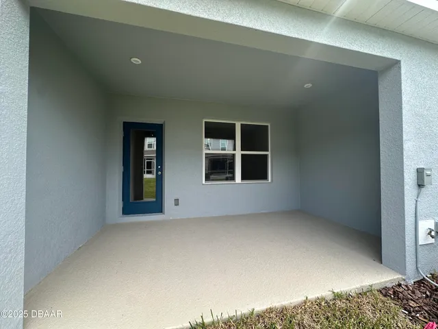 a view of an empty room and a window