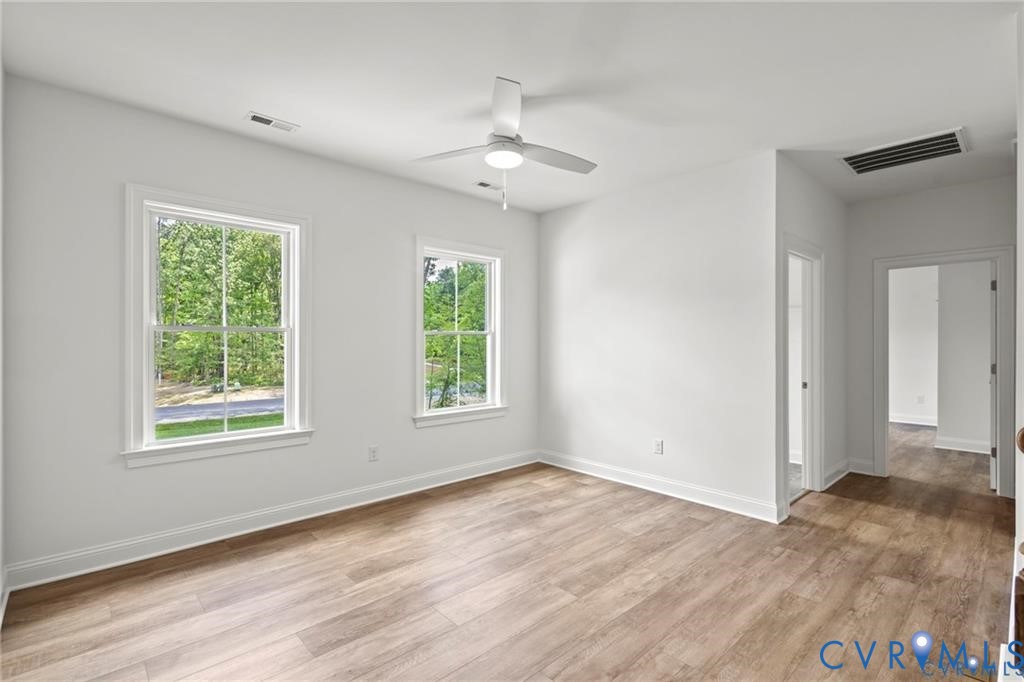 4927 Gooden Trail Quinton, VA 23141 - Photo 11 of 22 a view of an empty room with wooden floor and a window