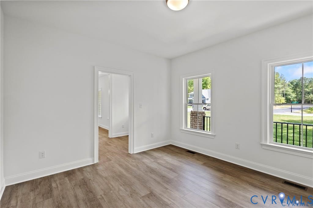 4927 Gooden Trail Quinton, VA 23141 - Photo 14 of 22 an empty room with wooden floor and windows
