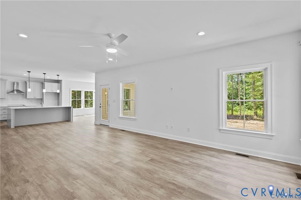 4927 Gooden Trail Quinton, VA 23141 - Photo 17 of 22 an empty room with wooden floor and windows
