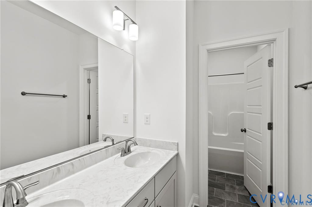 4927 Gooden Trail Quinton, VA 23141 - Photo 20 of 22 a bathroom with a granite countertop sink a toilet and shower