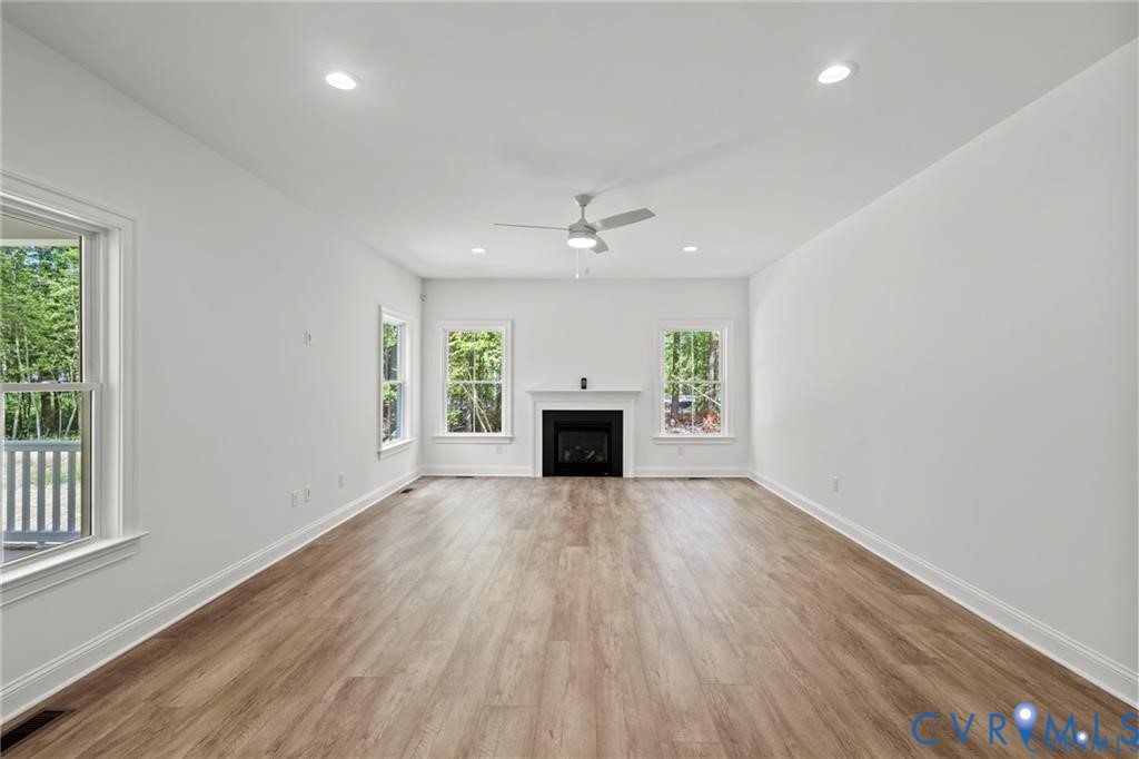 4927 Gooden Trail Quinton, VA 23141 - Photo 21 of 22 an empty room with windows and a fireplace