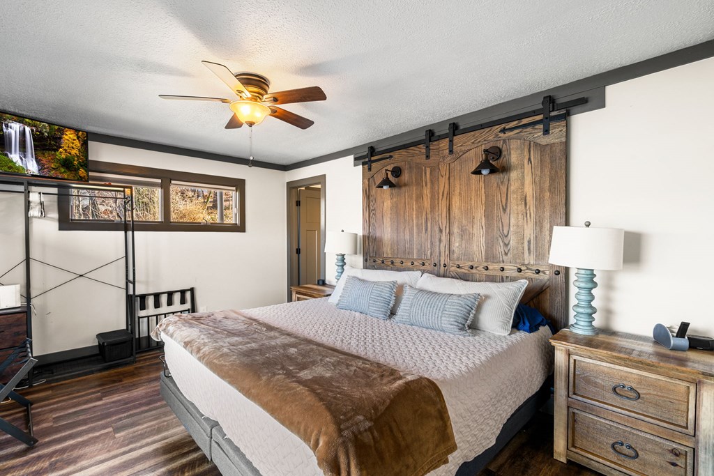 314 Kilpatrick Point Drive Hayesville, NC 28904 - Photo 20 of 50 a bedroom with a bed and a chandelier