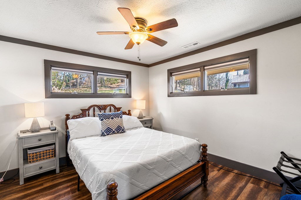 314 Kilpatrick Point Drive Hayesville, NC 28904 - Photo 23 of 50 a bedroom with a large bed and a chandelier