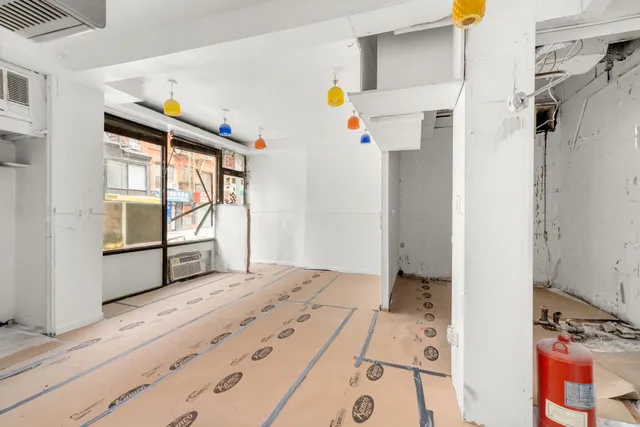 a view of a dining room and livingroom with furniture window and wooden floor