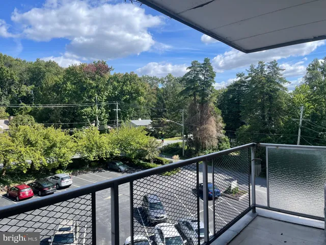 a view of a balcony with flower plants