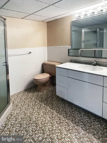 a bathroom with a toilet a sink and shower