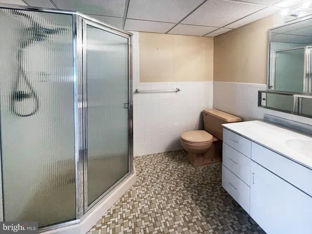 a bathroom with a shower toilet and sink