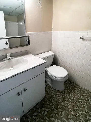 a bathroom with a sink a toilet and mirror