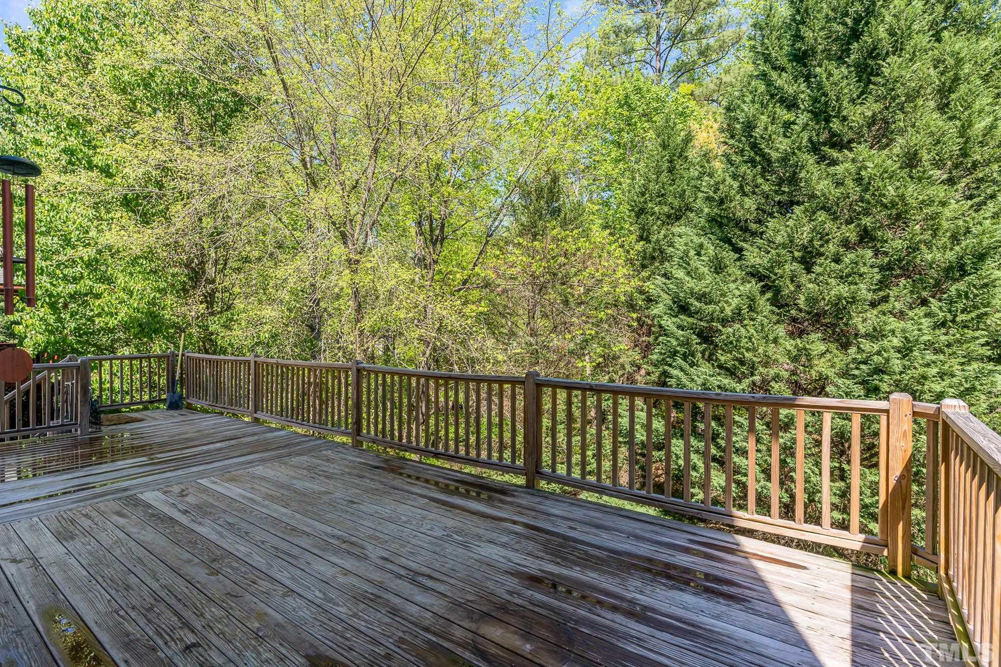 7920 Milltrace Run Raleigh, NC 27615 - Photo 6 of 9 a view of deck with wooden floor and outdoor seating