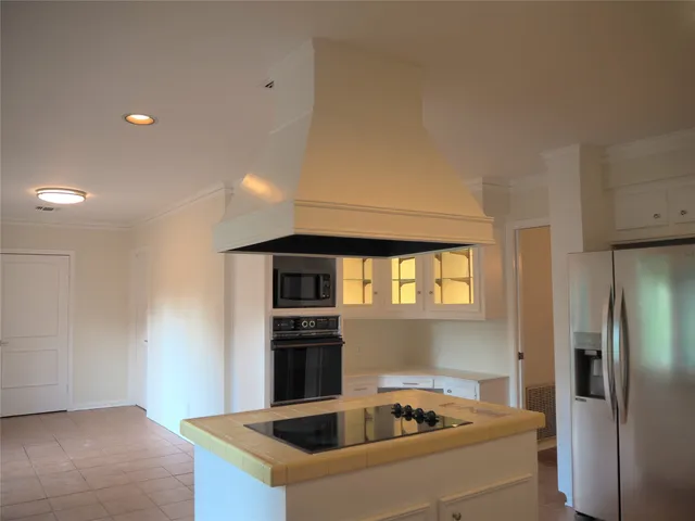 a view of a room with wooden floor and ceiling fan
