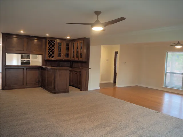a large kitchen with stainless steel appliances granite countertop a sink and a refrigerator