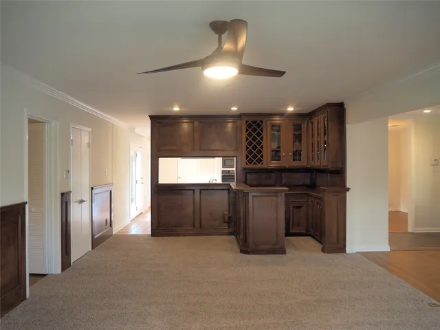 a view of an empty room with a fireplace and a window