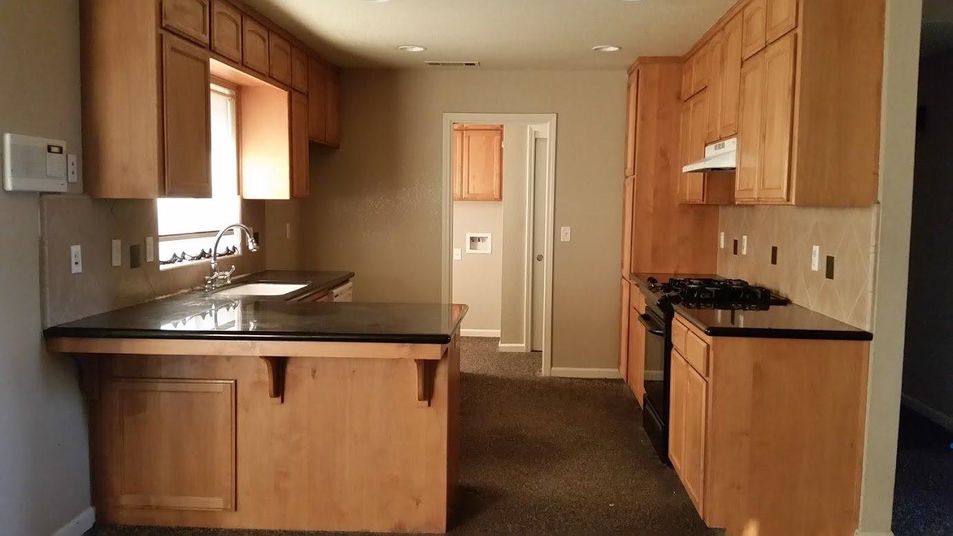 16714 Paula Road Madera, CA 93636 - Photo 4 of 10 Kitchen. Nice black granite countertop.