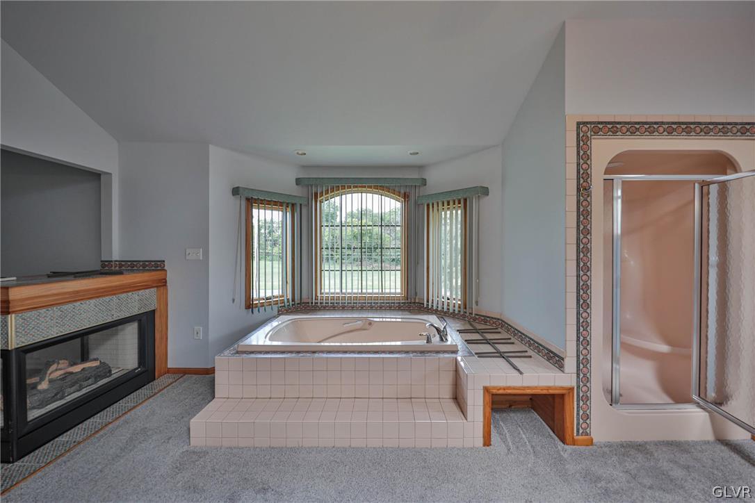 4682 Ash Drive Nazareth, PA 18064 - Photo 23 of 40 a living room with a fireplace and a floor to ceiling window