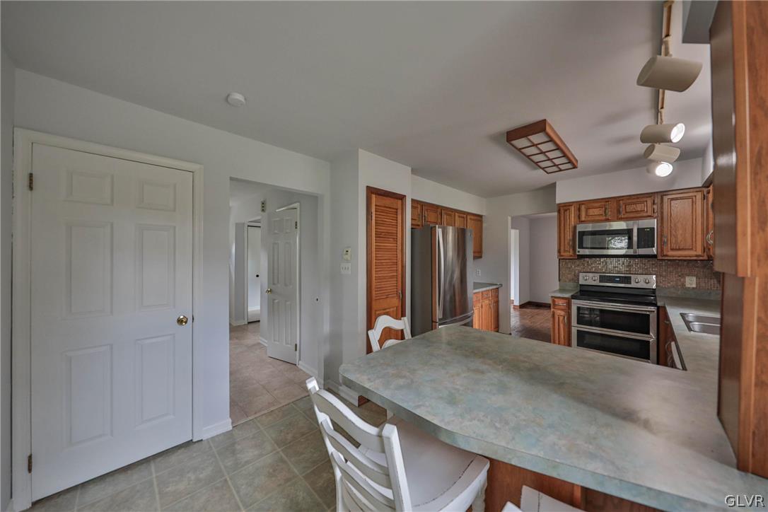 4682 Ash Drive Nazareth, PA 18064 - Photo 31 of 40 a kitchen with stainless steel appliances a stove refrigerator and microwave