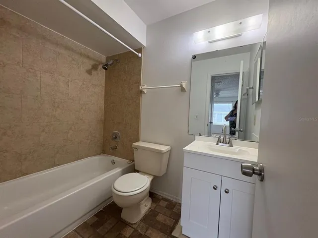 a bathroom with a toilet a sink and bathtub