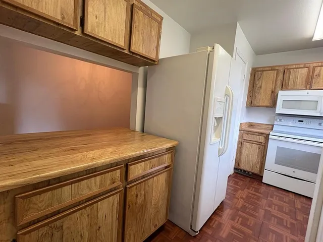 a kitchen with a refrigerator and cabinets
