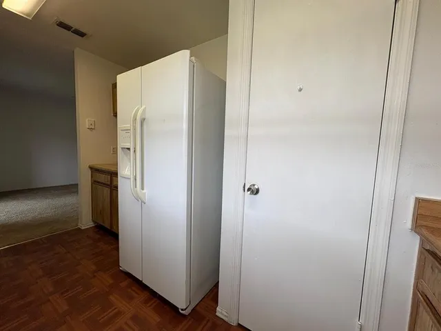 a refrigerator freezer sitting inside of a kitchen
