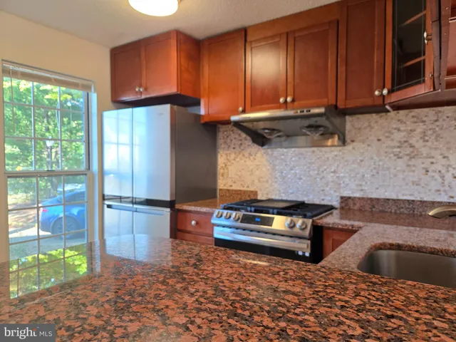 a kitchen with refrigerator and window