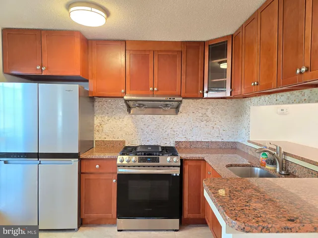 a kitchen with refrigerator and window