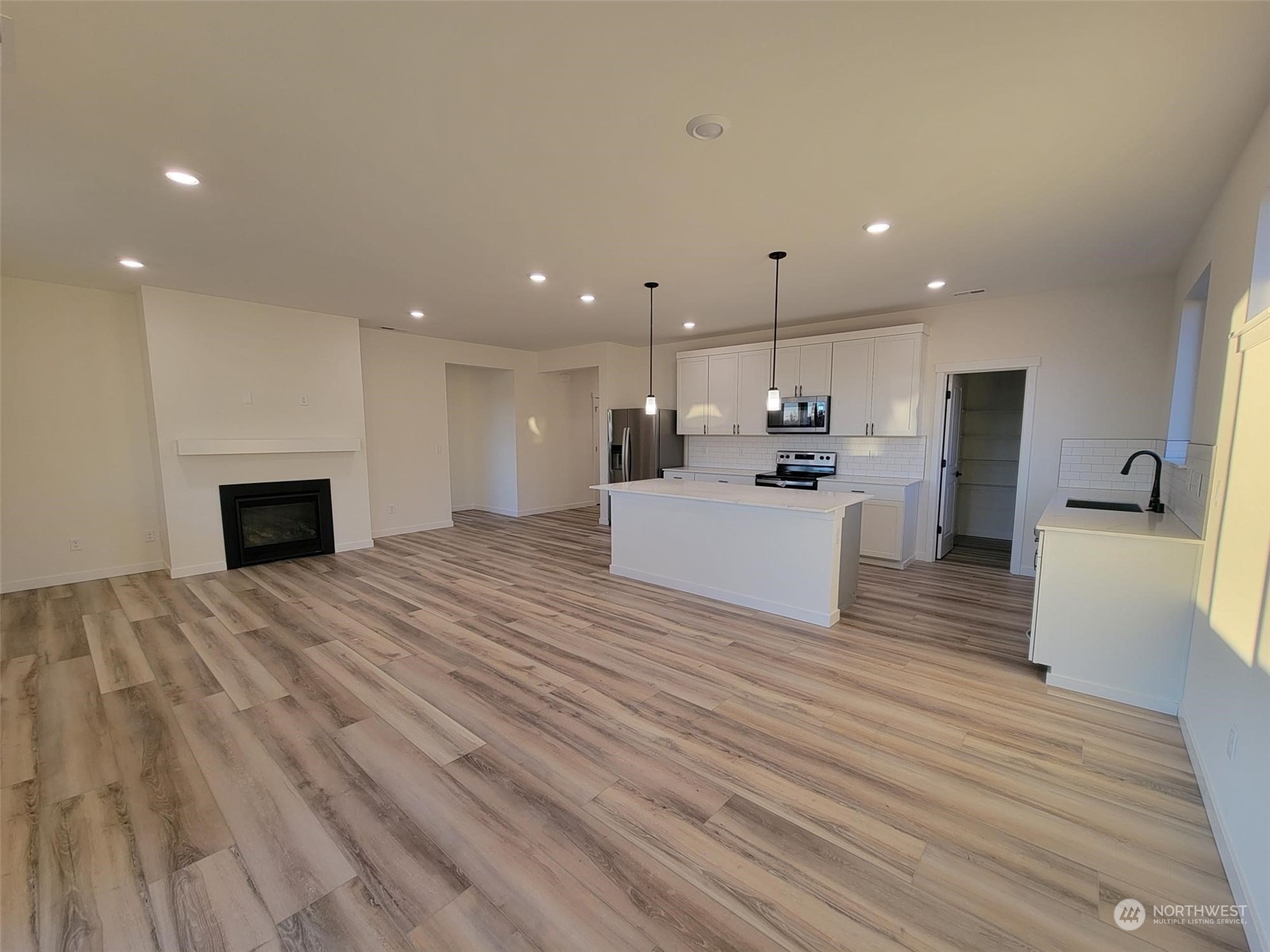 3545 Edith Avenue, Unit 28 Enumclaw, WA 98022 - Photo 5 of 10 a view of an empty room with kitchen and fireplace