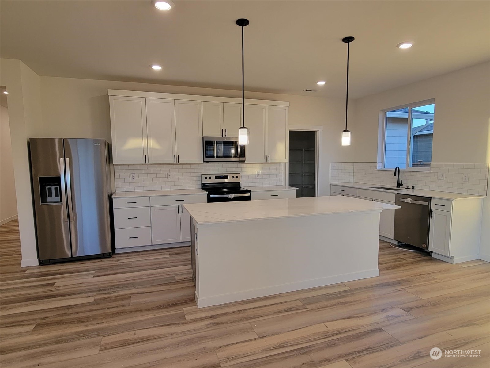 3545 Edith Avenue, Unit 28 Enumclaw, WA 98022 - Photo 6 of 10 a large white kitchen with stainless steel appliances