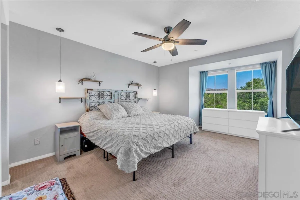 76 Via Sovana Santee, CA 92071 - Photo 13 of 34 a bedroom with a bed and a large window