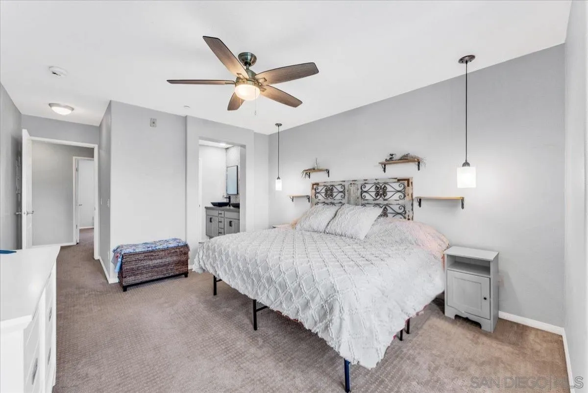 76 Via Sovana Santee, CA 92071 - Photo 14 of 34 a bedroom with a bed and a chandelier