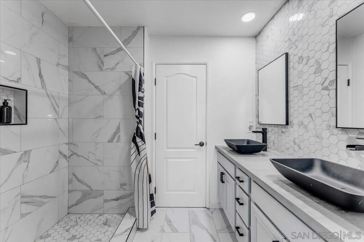 76 Via Sovana Santee, CA 92071 - Photo 16 of 34 a bathroom with a sink and a mirror with shower