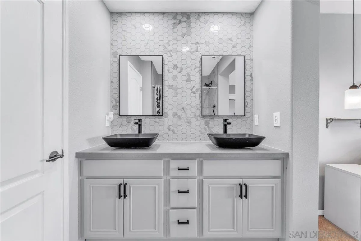 76 Via Sovana Santee, CA 92071 - Photo 17 of 34 a bathroom with double sink and a mirror
