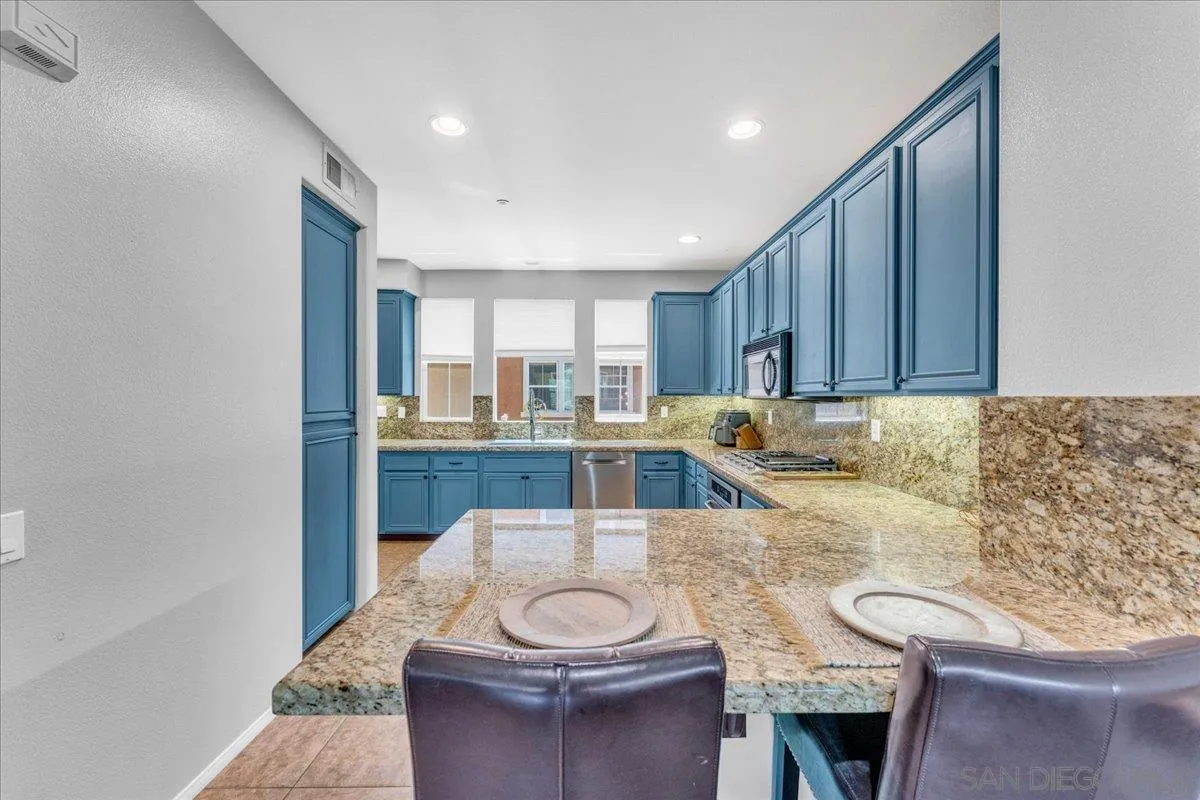 76 Via Sovana Santee, CA 92071 - Photo 2 of 34 a kitchen with stainless steel appliances granite countertop a sink and a refrigerator
