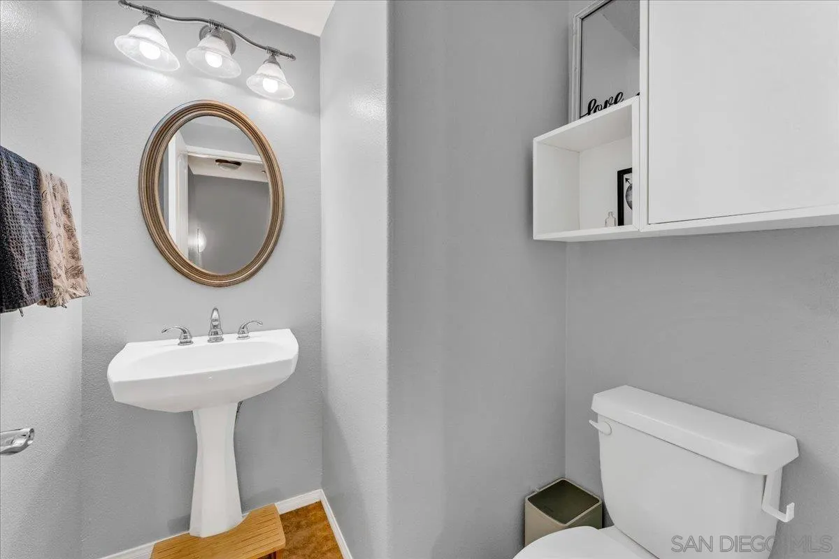 76 Via Sovana Santee, CA 92071 - Photo 24 of 34 a bathroom with a toilet sink and mirror