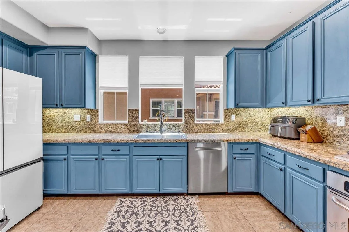 76 Via Sovana Santee, CA 92071 - Photo 3 of 34 a kitchen with stainless steel appliances granite countertop a sink stove and refrigerator