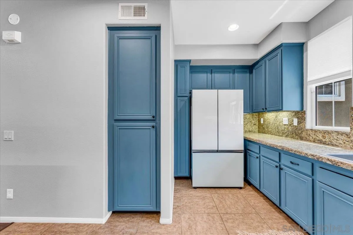 76 Via Sovana Santee, CA 92071 - Photo 4 of 34 a kitchen with a refrigerator and a sink