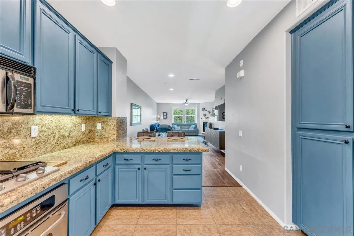 76 Via Sovana Santee, CA 92071 - Photo 5 of 34 a kitchen with granite countertop a sink and cabinets