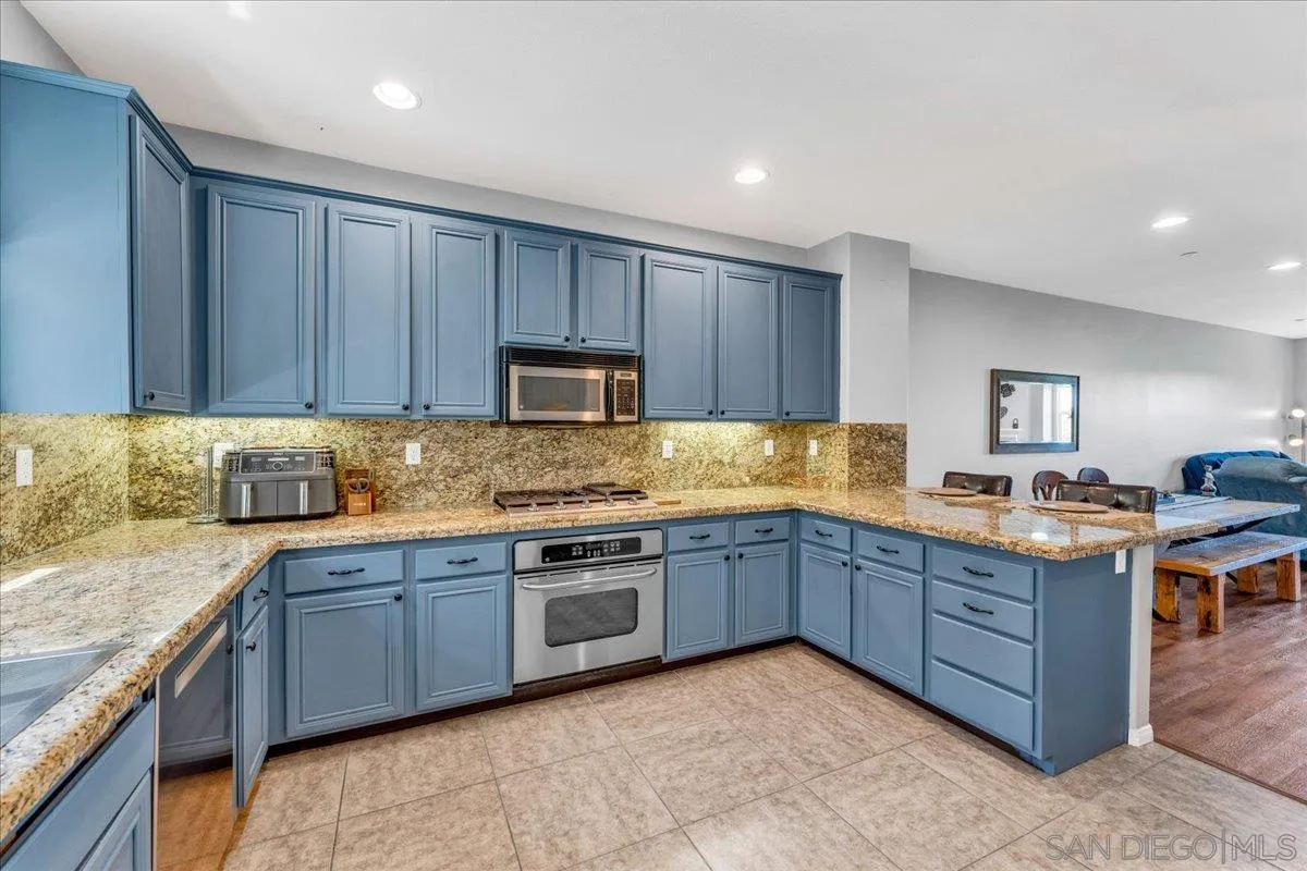 76 Via Sovana Santee, CA 92071 - Photo 6 of 34 a kitchen with stainless steel appliances granite countertop wooden cabinets a sink and dishwasher