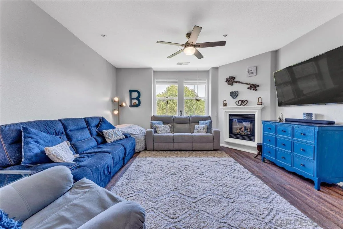 76 Via Sovana Santee, CA 92071 - Photo 8 of 34 a living room with furniture a flat screen tv and a fireplace