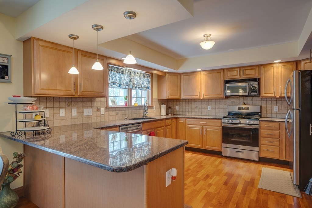 265 Renfrew Street Arlington, MA 02476 - Photo 11 of 39 a kitchen with stainless steel appliances granite countertop a sink a stove and cabinets