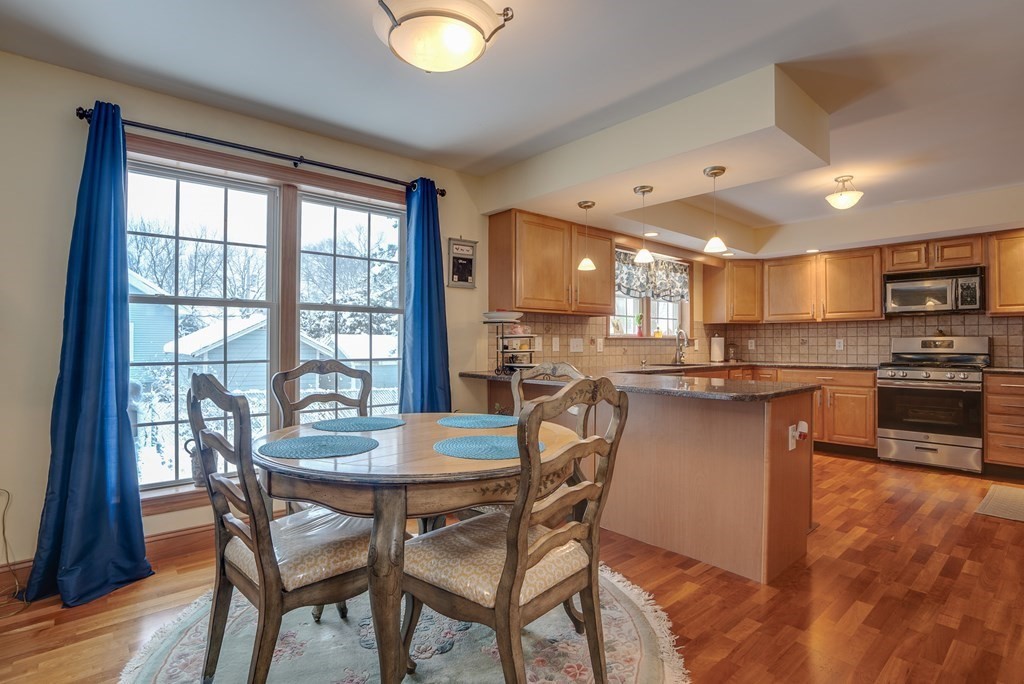 265 Renfrew Street Arlington, MA 02476 - Photo 12 of 39 a view of a dining room with furniture and a kitchen