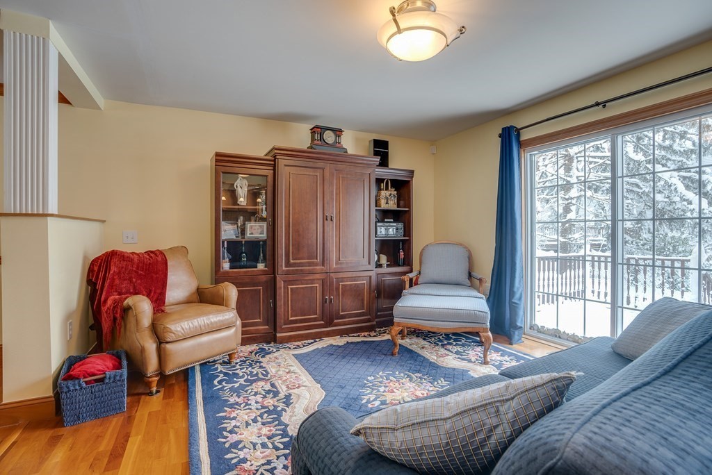 265 Renfrew Street Arlington, MA 02476 - Photo 13 of 39 a living room with furniture and a floor to ceiling window