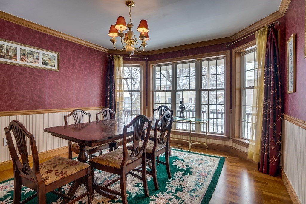 265 Renfrew Street Arlington, MA 02476 - Photo 17 of 39 a view of a dining room with furniture wooden floor and a chandelier