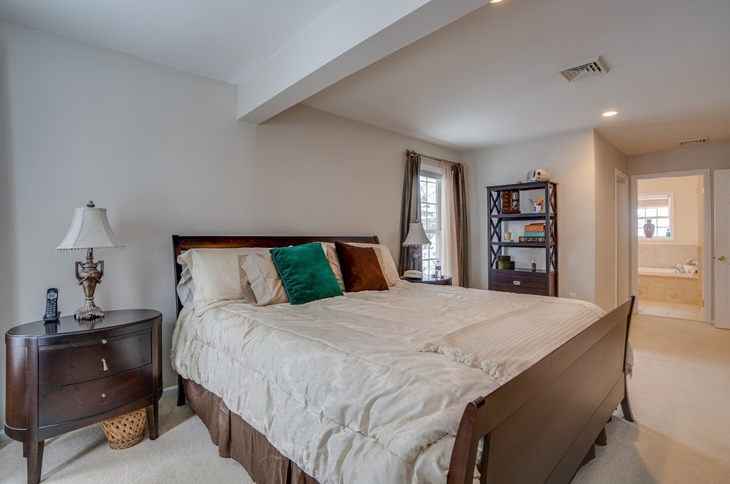 265 Renfrew Street Arlington, MA 02476 - Photo 21 of 39 a bedroom with a bed and a dresser