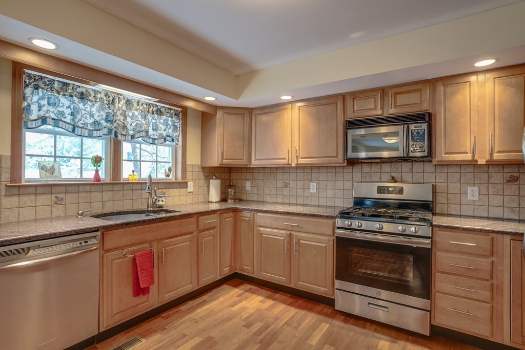265 Renfrew Street Arlington, MA 02476 - Photo 10 of 39 a kitchen with stainless steel appliances a stove sink and cabinets