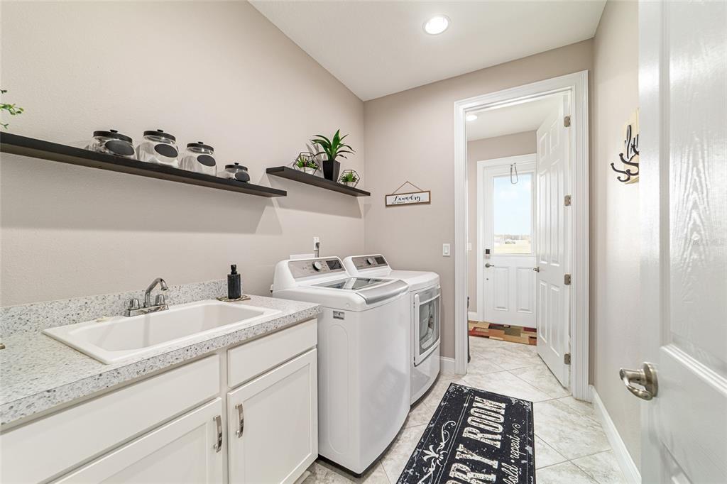 1983 Northwest 79th Loop Ocala, FL 34475 - Photo 54 of 97 a bathroom with a sink and mirror with toilet
