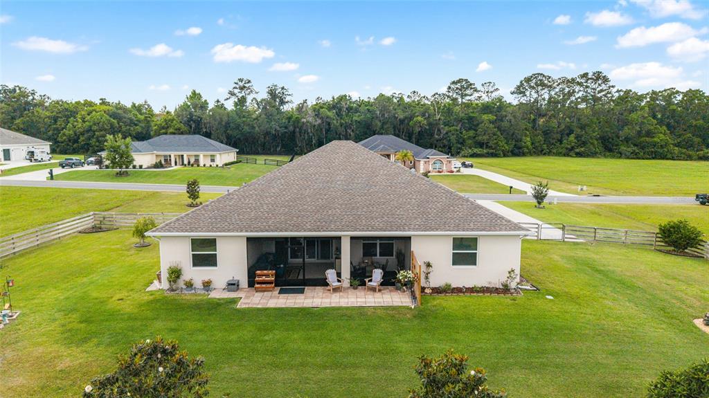1983 Northwest 79th Loop Ocala, FL 34475 - Photo 74 of 97 a front view of a house with garden and swimming pool