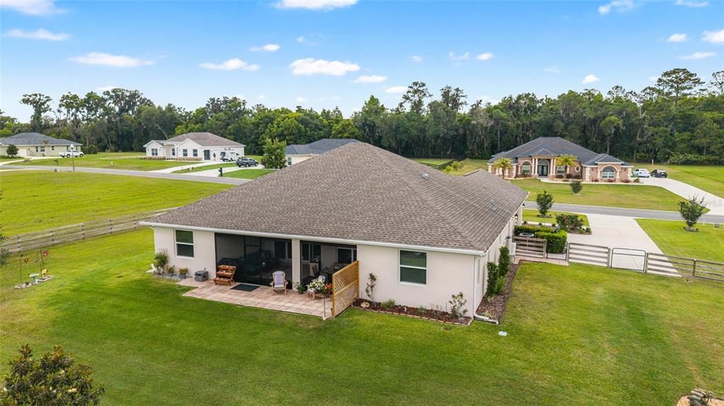 1983 Northwest 79th Loop Ocala, FL 34475 - Photo 75 of 97 a aerial view of a house with swimming pool and a yard